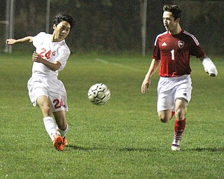 William D. Lewis The Vindicator Mooney's Mark Armile(24), left, and Fitch's Jarrett Knight(1) go for the ball during 1rst period action Oct. 4, 2016 at Simon Soccer Park in Struthers.