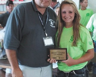 SPECIAL TO THE VINDICATOR
Green Leaf Inc. of Fontanet, Ind., Tractor Supply Co. and 4-H Youth Development announced Kylie McLean, right, of Salem, as the winner of the 2016 4-H Bright Futures Award. McLean is a member of Goshen Good Growers 4-H Club and was selected for the award in recognition for her project work in dairy. She received a $25 gift card and plaque as the Mahoning County winner from Brian Beck, left, Dairy committee member. The award was launched in Indiana in 2014 and has expanded to Ohio and Illinois to include more than 300 counties across three states.