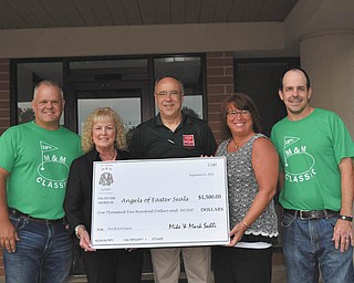 SPECIAL TO THE VINDICATOR
Mike and Mark Sahli presented a $1,500 check to representatives of Angels of Easter Seals. The funds were raised at the Sahlis’ 18th annual M&M Golf Classic which took place Sept. 4 at Mill Creek Park Golf Course. There were 144 golfers participating. The Sahlis founded the classic as a benefit for local charities throughout the Mahoning Valley. Those attending the presentation were Mike Sahli, left; Lynn Sahli, former president of the Angels of Easter Seals; Tim Nelson, president and CEO of Easter Seals and Youngstown Hearing & Speech; Shelly LaBerto, president of the Angels of Easter Seals; and Mark Sahli.