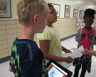 Neighbors | Alexis Bartolomucci.Some of the students at Robinwood Lane Elementary stopped to figure out which way to go to find the hidden Pokemon on Sept. 16.
