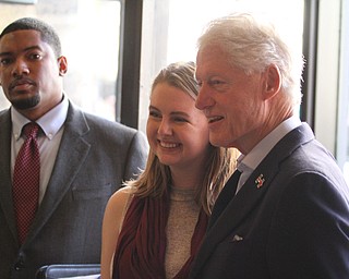 Nikos Frazier | The Vindicator..Former President Bill Clinton poses for a photo with Greta Frost at Joe Maxx Coffee Company in downtown Youngstown.