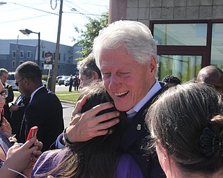 Nikos Frazier | The Vindicator..Former President Bill Clinton embraces newly registered voter, Bethany Tomsich outside the Trumbull County Hillary for America offices in Warren.