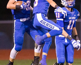 MICHAEL G TAYLOR | THE VINDICATOR- 10-07-16- 1st qtr, Reserve's #31 Adam Gatrell celebrates his 75 yard TD pass reception with his teammate #15 Ryan Demsky. McDonald Blue Devils vs Western Reserve Blue Devils at Western Reserve Stadium in Berlin Center, OH.