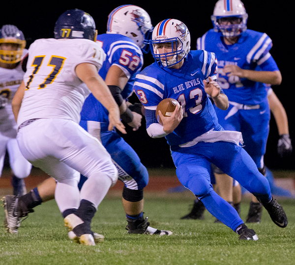 MICHAEL G TAYLOR | THE VINDICATOR- 10-07-16- 1st qtr, Reserve's #13 Wyatt Larimer cuts back against McDonald's #77 for a big gain. McDonald Blue Devils vs Western Reserve Blue Devils at Western Reserve Stadium in Berlin Center, OH.