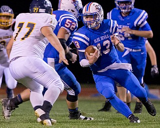 MICHAEL G TAYLOR | THE VINDICATOR- 10-07-16- 1st qtr, Reserve's #13 Wyatt Larimer cuts back against McDonald's #77 for a big gain. McDonald Blue Devils vs Western Reserve Blue Devils at Western Reserve Stadium in Berlin Center, OH.