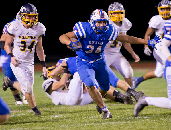 MICHAEL G TAYLOR | THE VINDICATOR- 10-07-16- 2nd qtr, Reserve's #34 Jack Cappabiancal looks fordaylight as McDonald's #34 Dale Wolford chases. McDonald Blue Devils vs Western Reserve Blue Devils at Western Reserve Stadium in Berlin Center, OH.
