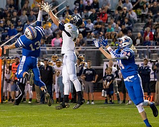 MICHAEL G TAYLOR | THE VINDICATOR- 10-07-16- 1st qtr, Reserve's #13 Wyatt Larimer tips the pass away from McDonald's #82 Joe Sudol.  Reserve's #13 Wyatt Larimer intercepted the ball. McDonald Blue Devils vs Western Reserve Blue Devils at Western Reserve Stadium in Berlin Center, OH.
