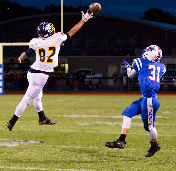 MICHAEL G TAYLOR | THE VINDICATOR- 10-07-16- 1st qtr, Reserve's #31 Adam Gatrell waits for the 75 yard TD pass as McDonald's #82 Joe Sudol barely tips the pass.   McDonald Blue Devils vs Western Reserve Blue Devils at Western Reserve Stadium in Berlin Center, OH.