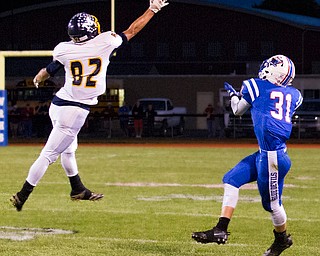 MICHAEL G TAYLOR | THE VINDICATOR- 10-07-16- 1st qtr, Reserve's #31 Adam Gatrell waits for the 75 yard TD pass as McDonald's #82 Joe Sudol barely tips the pass.   McDonald Blue Devils vs Western Reserve Blue Devils at Western Reserve Stadium in Berlin Center, OH.