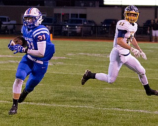 MICHAEL G TAYLOR | THE VINDICATOR- 10-07-16- 1st qtr, Reserve's #31 Adam Gatrell takes off for a 75 yard TD pass reception as McDonald's #82 Joe Sudol watches. McDonald Blue Devils vs Western Reserve Blue Devils at Western Reserve Stadium in Berlin Center, OH.