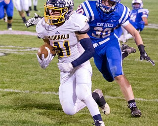MICHAEL G TAYLOR | THE VINDICATOR- 10-07-16- 1st qtr, McDonald's #31 Alex Cintron catches a 39 yard pass as  Reserve's #30 Ryan Slaven tries for the tackle. McDonald's #31 Alex Cintron was caught at the 5 yard line. McDonald Blue Devils vs Western Reserve Blue Devils at Western Reserve Stadium in Berlin Center, OH.