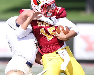 Nikos Frazier | The Vindicator..Mooney Quarterback Antonio Page(15) is taken down by Canisius' Mason Hoose(5) in the first half as Cardinal Mooney took on Canisius High School(Buffalo) at Stambaugh Stadium in Youngstown, Ohio on Sat, Oct. 8, 2016.