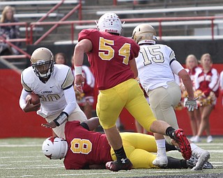Nikos Frazier | The Vindicator..Canisius Quarterback Jayce Johnson(10) is taken down by Mooney's Ray Anderson(8) in the first half as Cardinal Mooney took on Canisius High School(Buffalo) at Stambaugh Stadium in Youngstown, Ohio on Sat, Oct. 8, 2016.