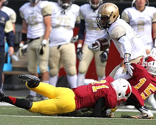 Nikos Frazier | The Vindicator..Canisius' Paul Woods(8) is taken down by Mooney's Antonio Page(15) in the first half as Cardinal Mooney took on Canisius High School(Buffalo) at Stambaugh Stadium in Youngstown, Ohio on Sat, Oct. 8, 2016.