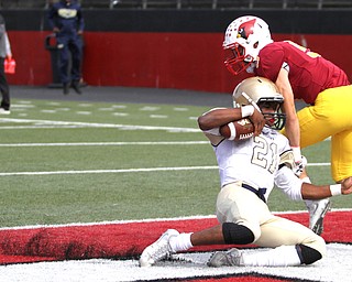 Nikos Frazier | The Vindicator..Canisius' Kenyatta Huston(21) is taken down in the Mooney end zone by Nico Marchionda(5) for a touchdown in the first half as Cardinal Mooney took on Canisius High School(Buffalo) at Stambaugh Stadium in Youngstown, Ohio on Sat, Oct. 8, 2016.