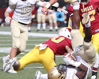 Nikos Frazier | The Vindicator..Canisius' RaeQwon Greer(11) lands after being tackled in the first half as Cardinal Mooney took on Canisius High School(Buffalo) at Stambaugh Stadium in Youngstown, Ohio on Sat, Oct. 8, 2016.