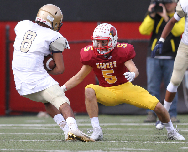 Nikos Frazier | The Vindicator..Mooney's Nico Marchionda(5) prepares to attempt to tackle Canisius' Paul Wood(8) in the second half as Cardinal Mooney took on Canisius High School(Buffalo) at Stambaugh Stadium in Youngstown, Ohio on Sat, Oct. 8, 2016.