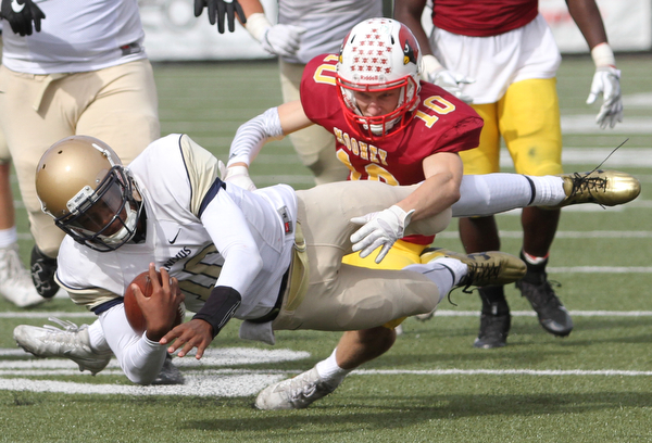 Nikos Frazier | The Vindicator..Canisius' Jayce Johnson(10) is taken down by Mooney's Pat Pelini(10) in the second half as Cardinal Mooney took on Canisius High School(Buffalo) at Stambaugh Stadium in Youngstown, Ohio on Sat, Oct. 8, 2016.