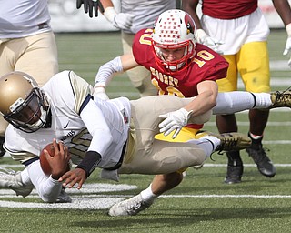 Nikos Frazier | The Vindicator..Canisius' Jayce Johnson(10) is taken down by Mooney's Pat Pelini(10) in the second half as Cardinal Mooney took on Canisius High School(Buffalo) at Stambaugh Stadium in Youngstown, Ohio on Sat, Oct. 8, 2016.