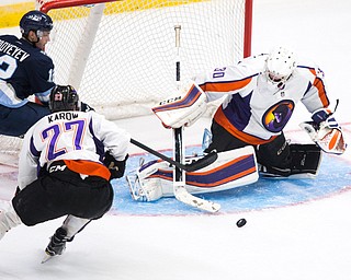 Youngstown Phantoms goalie Darion Hanson (30) makes a save on a shot from Madison Capitols forward Eugene Fadyeyev (12) during the second period at the Covelli Centre on October 8, 2016. Scott R. Galvin | Vindicator