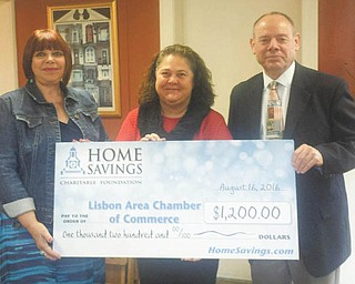 SPECIAL TO THE VINDICATOR
Home Savings Charitable Foundation recently donated $1,200 to the Lisbon Area Chamber of Commerce. Those present at the presentation were Susan Shank, left, president of the chamber; Becky Tolson, retail manager of Home Savings Lisbon office; and Brad Forrider, vice president of the chamber. The chamber promotes the development of commercial, financial, industrial and civil interests in Lisbon. A recent off-premise fire destroyed supplies needed for the upcoming 49th annual Johnny Appleseed Festival, which is hosted by the chamber, and the donation will go toward replacing the lost items. For information on the chamber call 330-424-1803 or visit lisbonareachamber.com.