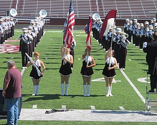 Neighbors | Alexis Bartolomucci.The Boardman High School flagline held flags while the marching band was performing the National Anthem on Sept. 13 for the Boardman elementary school students.
