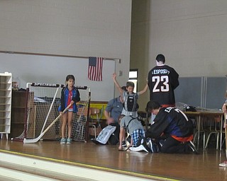 Neighbors | Alexis Bartolomucci.Three phantoms players and Tom Upton, the assistant coach, helped some Dobbins Elementary students get into goalie gear to play a small game of floor hockey on Sept. 20.
