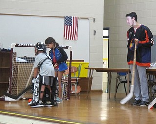 Neighbors | Alexis Bartolomucci.Students at Dobbins Elementary played floor hockey with some of  the Youngstown Phantoms hockey players on Sept. 20.