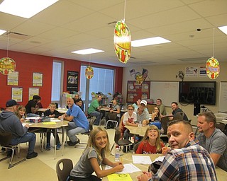 Neighbors | Alexis Bartolomucci.Students at Austintown Intermediate School and their fathers, grandfathers and other father-figures worked together on different activities and ate pizza during the WATCH D.O.G.S. kick off event on Sept. 26.