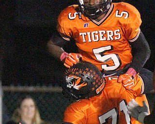 William D. Lewis/The Vindicator Howland's Tariq Ellis(5) is hoisted aloft after scoring during 1rst qtr action  Oct 13, 2016 action against Niles.. #71 not on roster