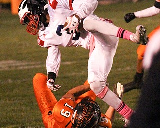 William D. Lewis/The Vindicator Niles' Jasson Faison(33) is tripped up by Howland's Keith Rounds(19) during Oct 13, 2016 action at Howland.