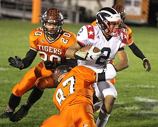 William D. Lewis/The Vindicator Niles' Jasson Faison(2) is wrapped up by Howland's Victor Williams(20) and Jacob Williams (87).