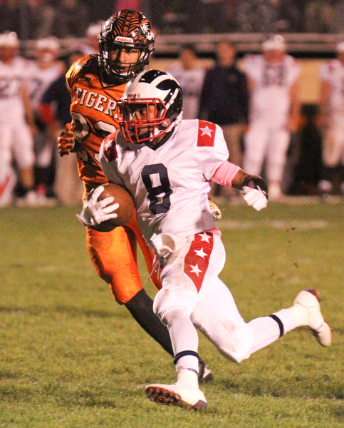 William D. Lewis/The Vindicator Niles' Jaylon Sanders(8) is chased by Howland's Stephen Baugh(23) during Oct 13, 2016 action at Howland.