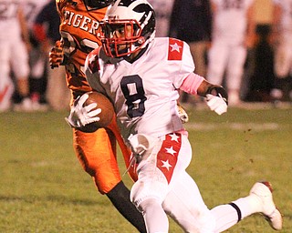 William D. Lewis/The Vindicator Niles' Jaylon Sanders(8) is chased by Howland's Stephen Baugh(23) during Oct 13, 2016 action at Howland.