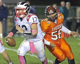William D. Lewis/The Vindicator Niles' Tlyer Skrbinovich(13) is chased by Howland's Brandon Matlock(56) during Oct 13, 2016 action at Howland.