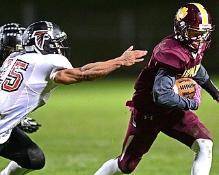 LIBERTY, OHIO - OCTOBER 13, 2016: Dra Rushton #1 of Liberty runs the football while avoiding the grasp of Jeremiah Knight #25 of Jefferson during the first half of their game Thursday night at Liberty High School. DAVID DERMER | THE VINDICATOR