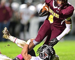 LIBERTY, OHIO - OCTOBER 13, 2016: Charles Packard #4 of Libert runs through Jeremiah Knight #25 of Jefferson during the first half of their game Thursday night at Liberty High School. DAVID DERMER | THE VINDICATOR