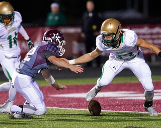 MICHAEL G TAYLOR | THE VINDICATOR- 10-14-16- 1st qtr, on bad 4th down snap on a punt attempt, Boardman's #32 Neil Bevacqua swoops in for the loose ball as Ursuline #13 looks tries to make the recovery.   Ursuline Irish vs Boardman Spartans at Spartan Stadium in Boardman, OH.