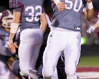 MICHAEL G TAYLOR | THE VINDICATOR- 10-14-16- 1st qtr, on bad 4th down snap on a punt attempt, Boardman's #50 Steven Amstutz celebrates his teams recovery of the loose ball for a TD.   Ursuline Irish vs Boardman Spartans at Spartan Stadium in Boardman, OH.