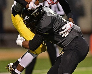 WARREN, OHIO - OCTOBER 14, 2016: Naz Battee-Diggs #7 of Warren Harding picks up kick returner Darrell Jackson #17 of Mooney on a kick return during the first half of their game Friday nights game at Molenkamp Stadium. DAVID DERMER | THE VINDICATOR