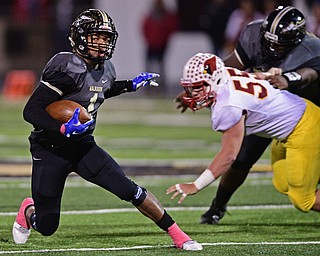 WARREN, OHIO - OCTOBER 14, 2016: Lynn Bowden #1 of Warren Harding plants to run away from Vinny Santisi #55 of Mooney during the first half of their game Friday nights game at Molenkamp Stadium. DAVID DERMER | THE VINDICATOR