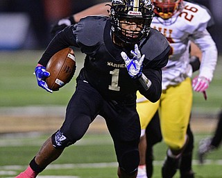 WARREN, OHIO - OCTOBER 14, 2016: Lynn Bowden #1 of Warren Harding runs upfield away from Andre McCoy #26 of Mooney for extra yardage during the first half of their game Friday nights game at Molenkamp Stadium. DAVID DERMER | THE VINDICATOR