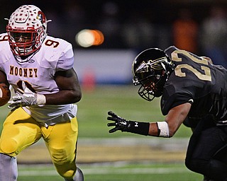 WARREN, OHIO - OCTOBER 14, 2016: Jaylen Hewlett #9 of Mooney runs the football away from Elijah Burch #22 of Warren Harding during the first half of their game Friday nights game at Molenkamp Stadium. DAVID DERMER | THE VINDICATOR