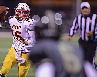 WARREN, OHIO - OCTOBER 14, 2016: Antonio Page #15 of Mooney pumps fakes with he football while scrambling to freeze Jalen Hooks #6 of Warren Harding to run for extra yardage during the second half of their game Friday nights game at Molenkamp Stadium. DAVID DERMER | THE VINDICATOR