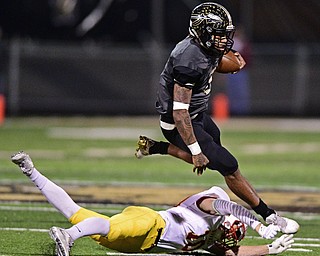 WARREN, OHIO - OCTOBER 14, 2016: Lynn Bowden #1 of Warren Harding has his feet taken out by Pat Pelini #10 of Mooney during the second half of their game Friday nights game at Molenkamp Stadium. DAVID DERMER | THE VINDICATOR