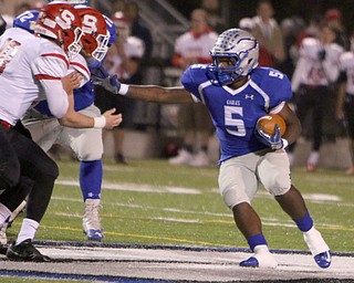 Hubbard's Rafael Morales (5) tries to get to the outside of the Struthers defense led by AJ Musolino (18) during the first quarter of Friday nights matchup at Hubbard High School.  Dustin Livesay  |  The Vindicator  10/14/16 Hubbard