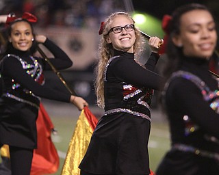 Colleen Davis of the Struthers High School marching band color guard twirls a flag during their halftime performance at Hubbard High School on Friday night. Dustin Livesay  |  The Vindicator  10/14/16  Hubbard.