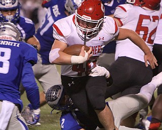 Nate Richards (40) of Struthers tries to break through a tackle by Hubbards David Hernandez (2) during the third quarter of Friday nights matchup at Hubbard High School.  Dustin Livesay  |  The Vindicator  10/14/16 Hubbard