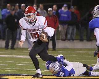 Struthers quarterback AJ Musolino (18) tries to break through an ankle tackle by Hubbard's Sheldon McGhee (28) during the fourth quarter of Friday nights matchup at Hubbard High School.  Dustin Livesay  |  The Vindicator  10/14/16 Hubbard