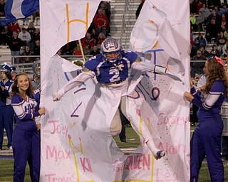 David Hernandez (2) of Hubbard burst through the sign leading the Eagles onto the field before the start of Friday nights matchup against Struthers at Hubbard High School. Dustin Livesay  |  The Vindicator  10/14/16  Hubbard.